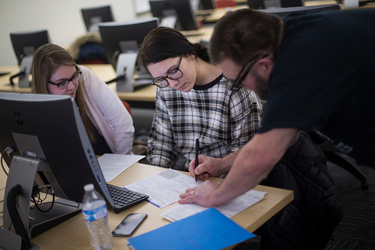 Taxpayers receive information on their tax return from a volunteer preparer, UW-Whitewater accounting student Jose Pincheira at Hyland Hall on Wednesday, February 20, 2019. (UW-Whitewater photo/Craig Schreiner)