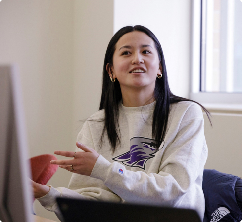 Marketing major Peyton Boelk talks with Andrew Dahl, associate professor of marketing, during a class in Hyland Hall on April 3, 2024. 