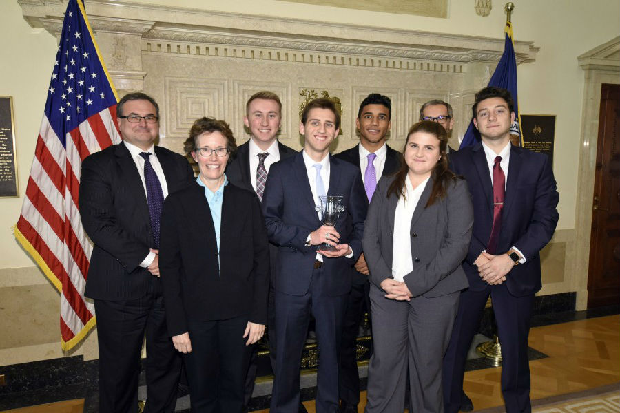 The UW-Whitewater College Fed Challenge Team stands with judges from the national competition. From left are Thomas Lubik, Senior Research Adviser of the Federal Reserve Bank of Richmond, Ellen Meade, Senior Adviser of the Federal Reserve Board’s Division of Monetary Affairs, Mark Ellis, Ronald Tittle, Alexandre Vieira, Taylor Griffith, Andrea Tambalotti, Assistant Vice President and Function Head of the Federal Reserve Bank of New York’s Macroeconomic and Monetary Studies Function and Alejandro Esquivel.