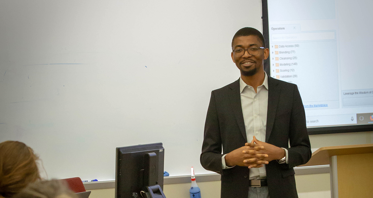 Assistant Professor Onochie Fan-Osuala addresses a classroom