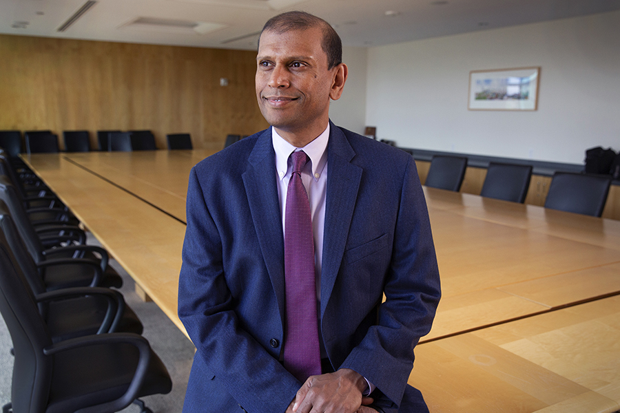 Paul Ambrose stands in an empty conference room