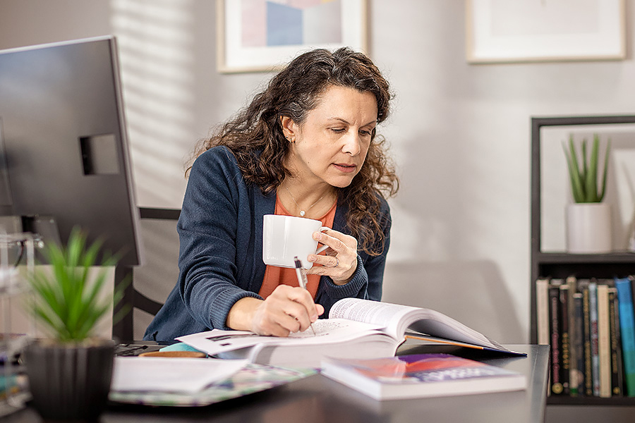 Woman studies at table in home