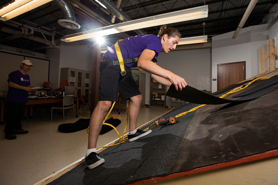 Connor Carrington ‘17, works on the original roofing workstation in the Ambrose Health Center