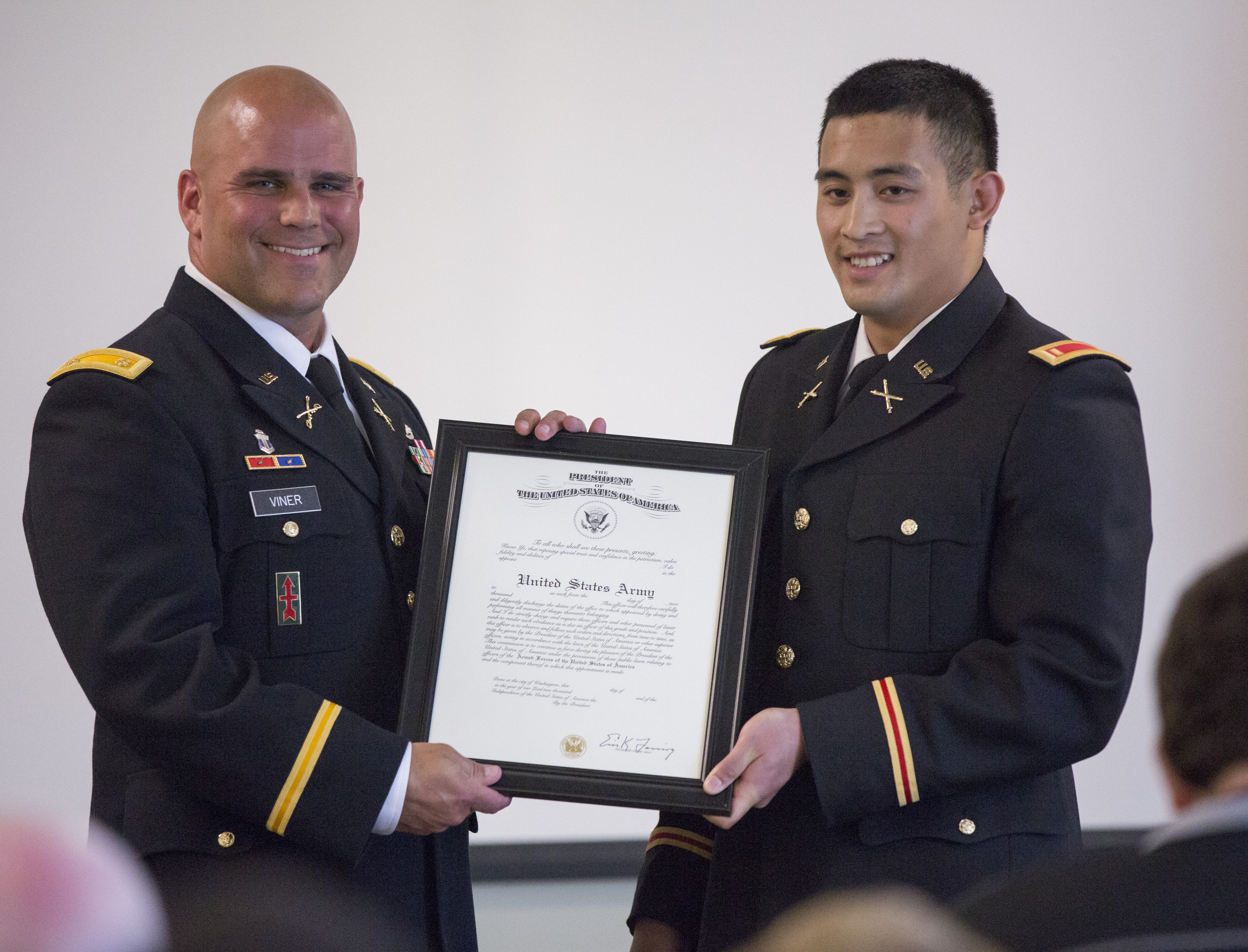 Student in uniform receiving a award