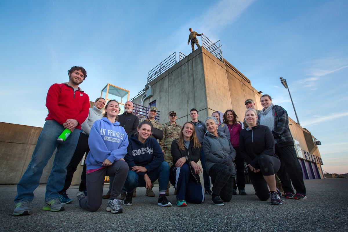 group of people standing infront a reppel tower