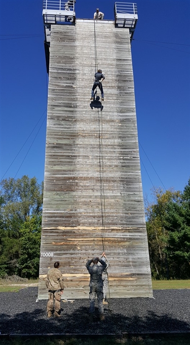 Student in uniform climbing a tower