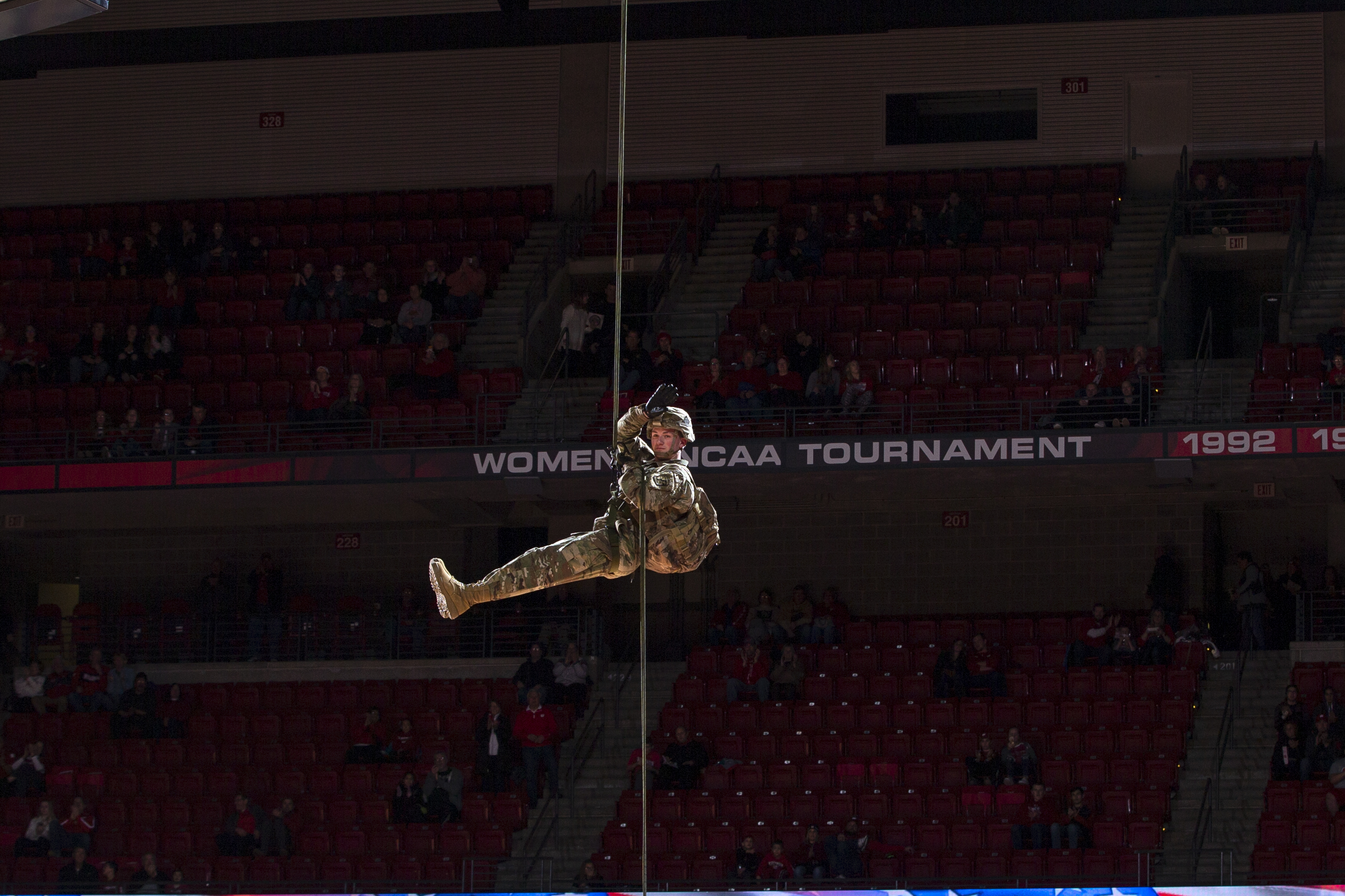 student in uniform rappeling down in UW-Madison building