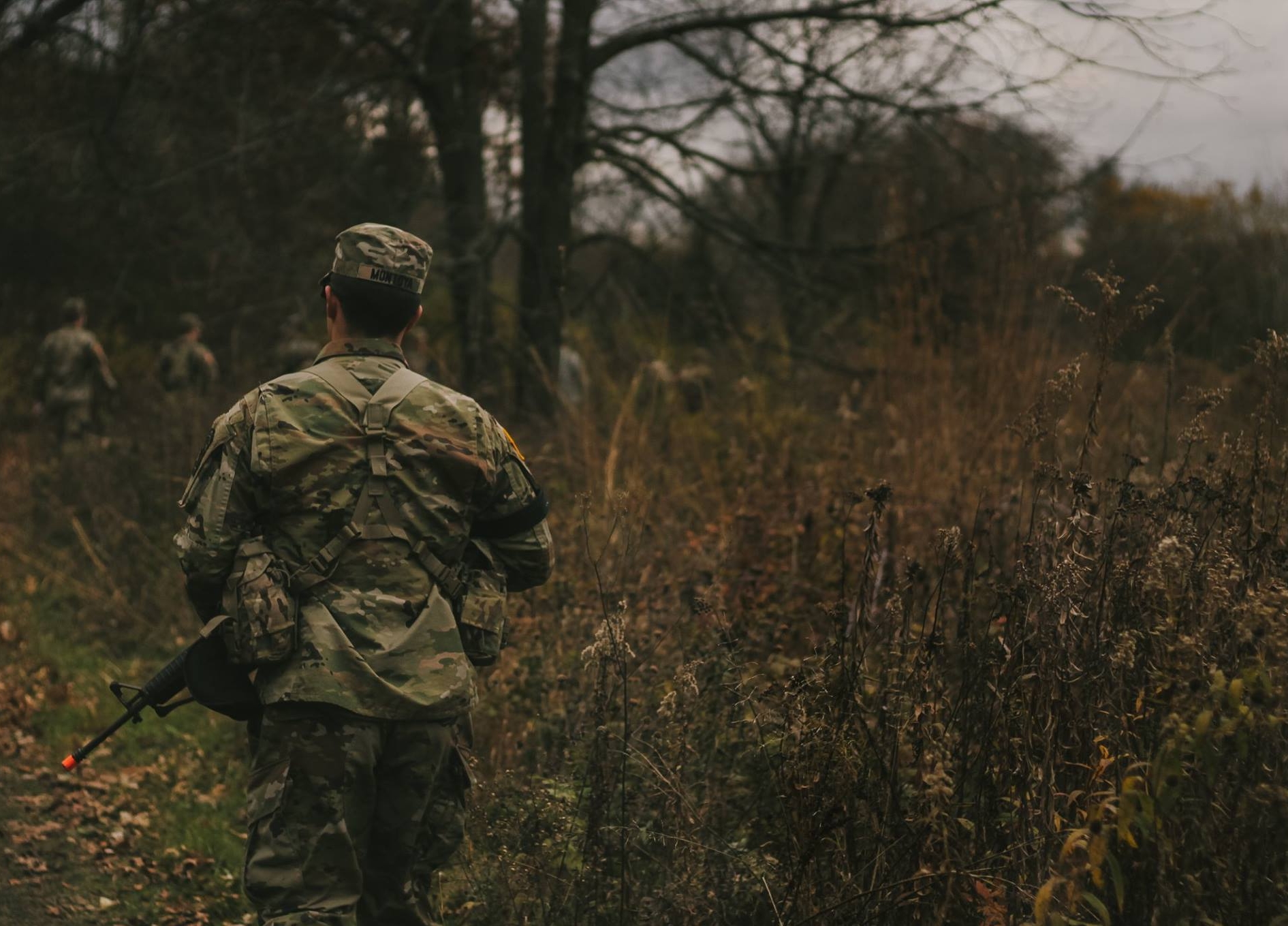 student in uniform on a mission through a field