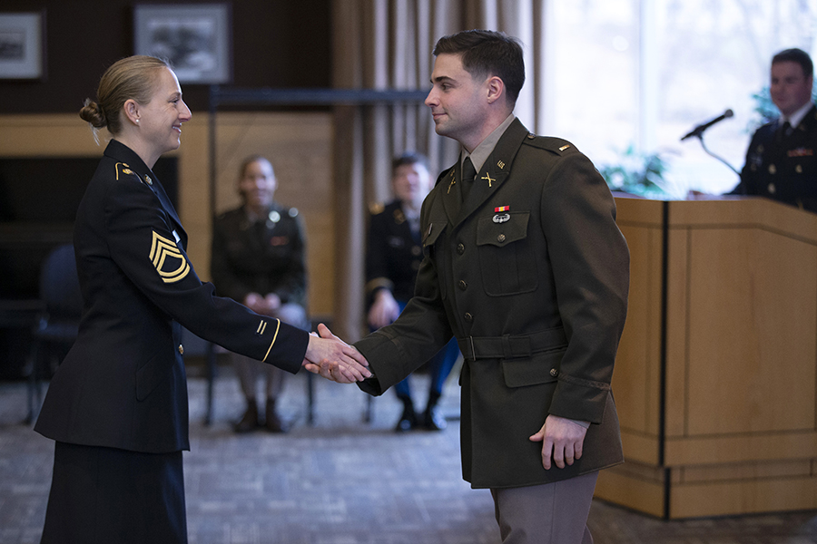 Two service people shake hands.