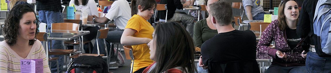 Dean of Students with students talking at University Center