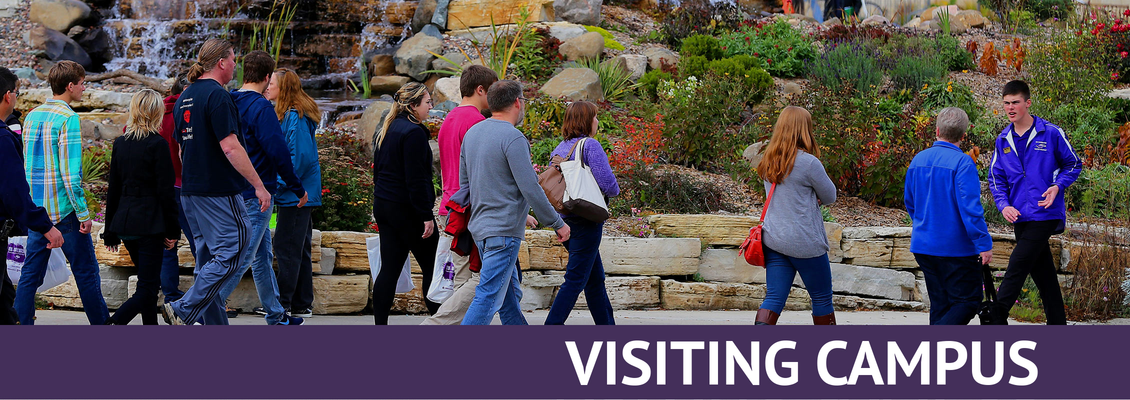 Visiting Campus: Student tour guide leads a group of parents and students