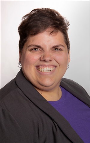 white woman in thirties with brown eyes and brown hair smiling