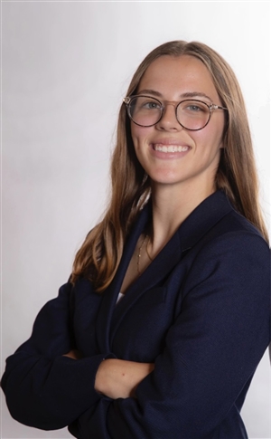 white woman in early twenties with long light brown hair and dark eyes smiling