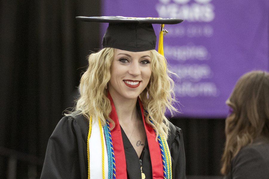 An international student smiles at graduation.