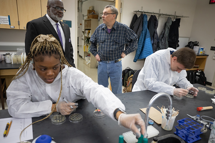 An international student works in a science lab.