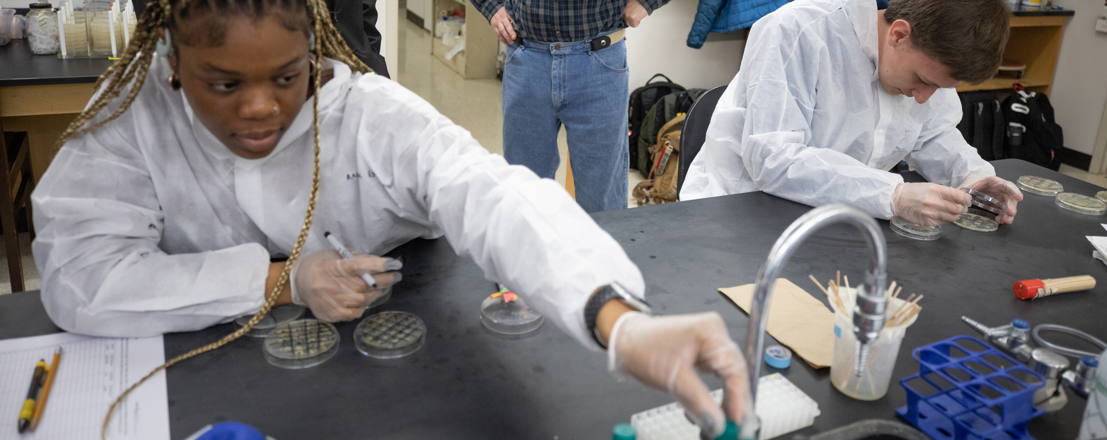 An international student works in a science lab.