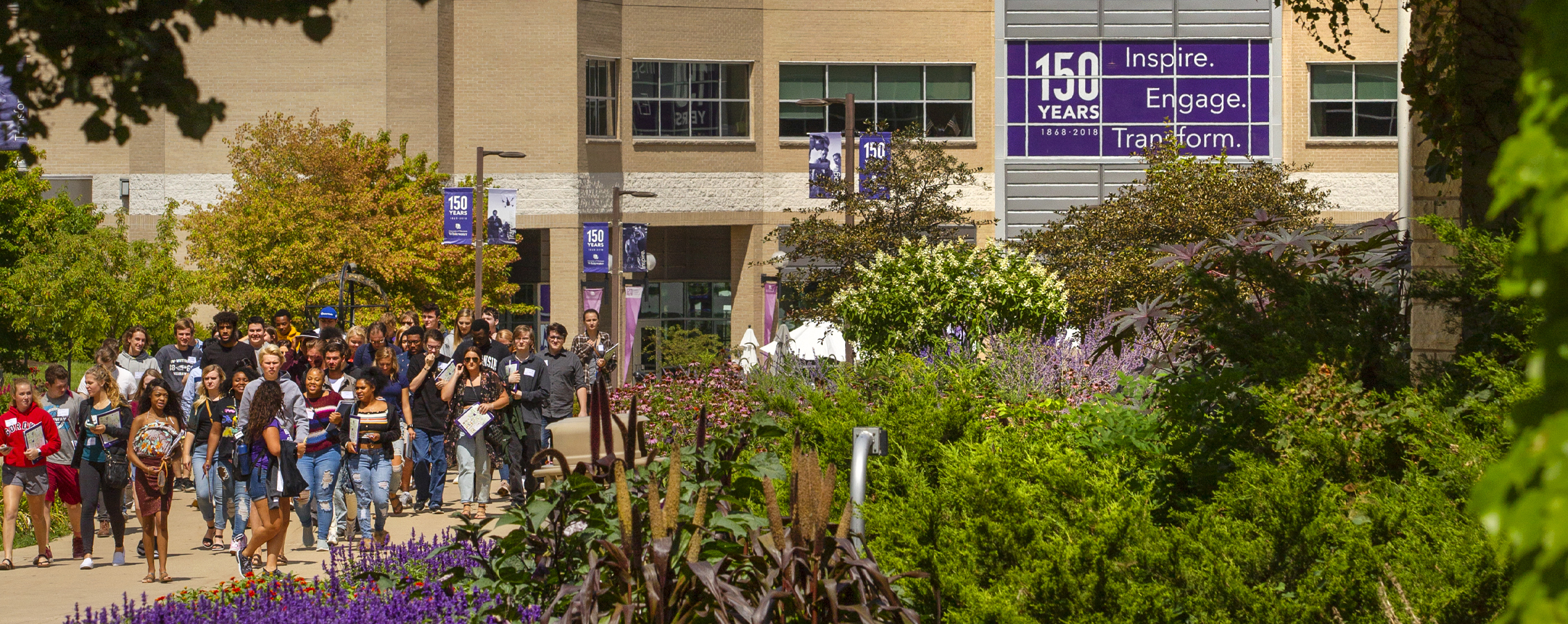 A campus tour in front of the University Center during summer.