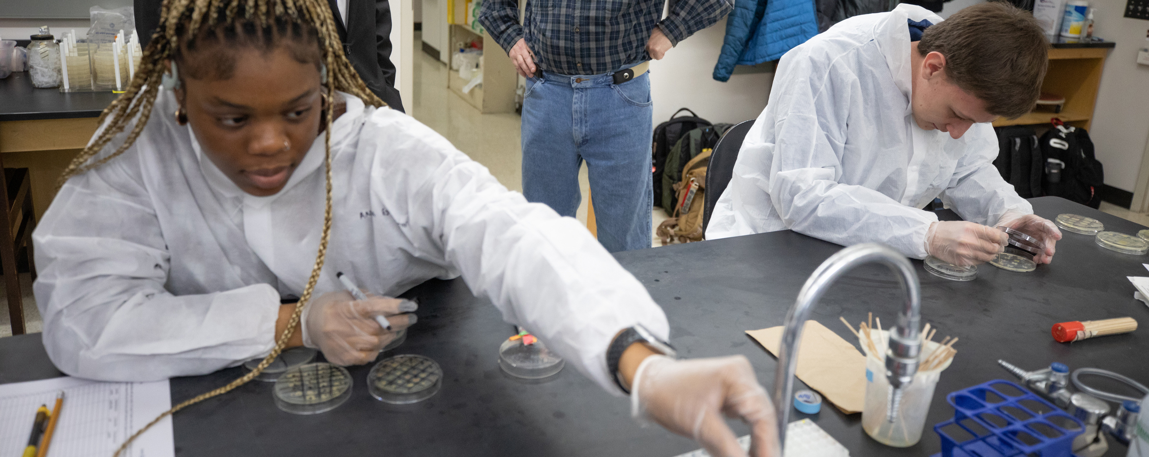 An international student from Nigeria works in a science lab.