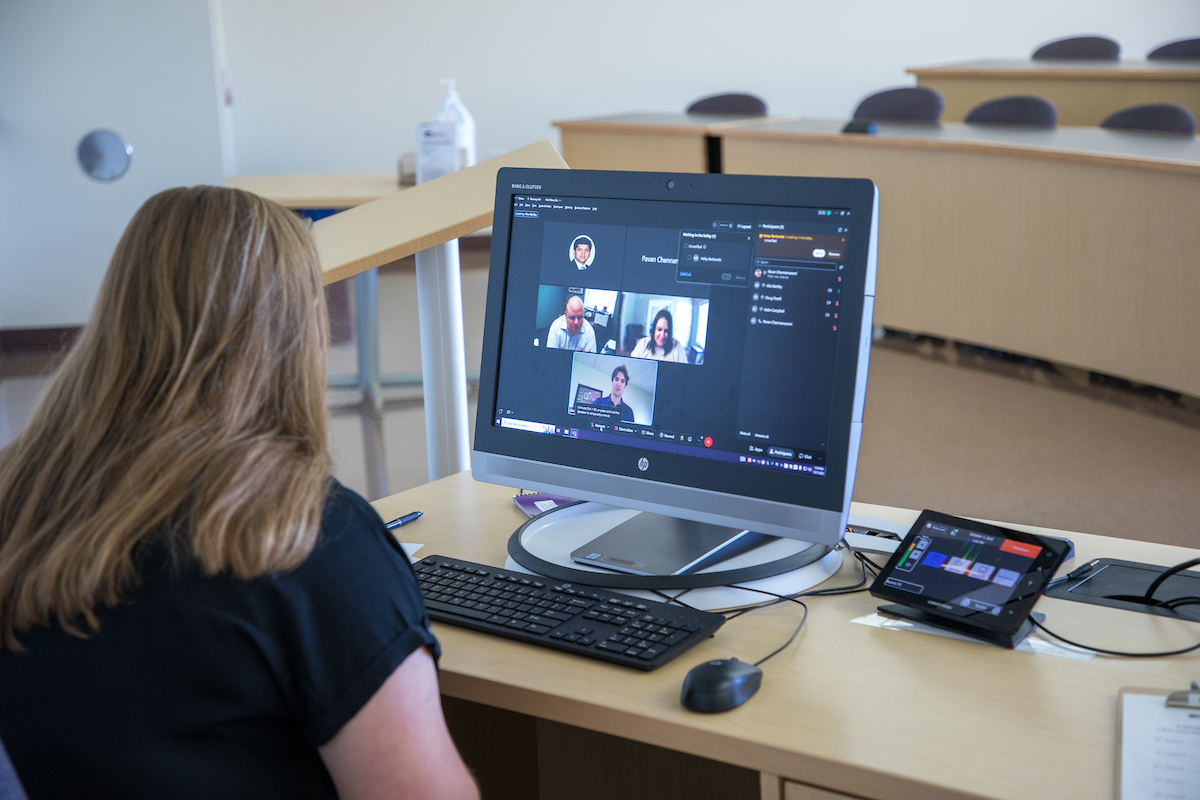 Professional on a laptop engaging in a webinar