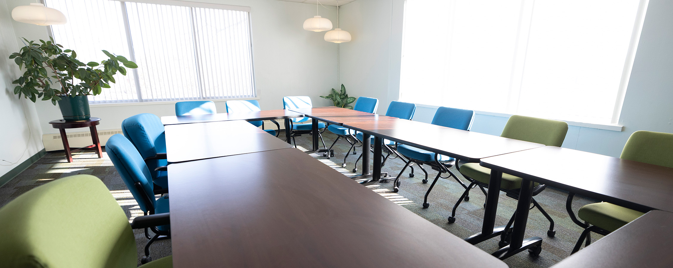 A meeting room with sun coming in through the window.