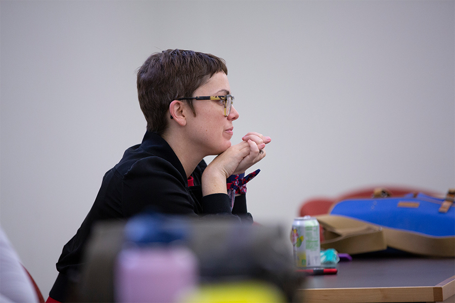 Stephanie Selvick listens to author and producer Jacob Tobia read from their book.