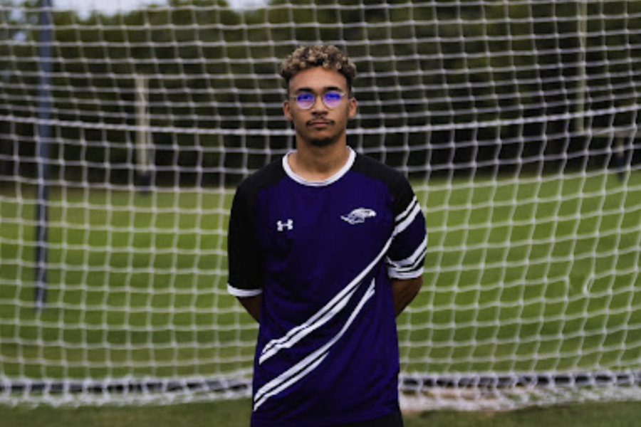 soccer player standing in front of the net