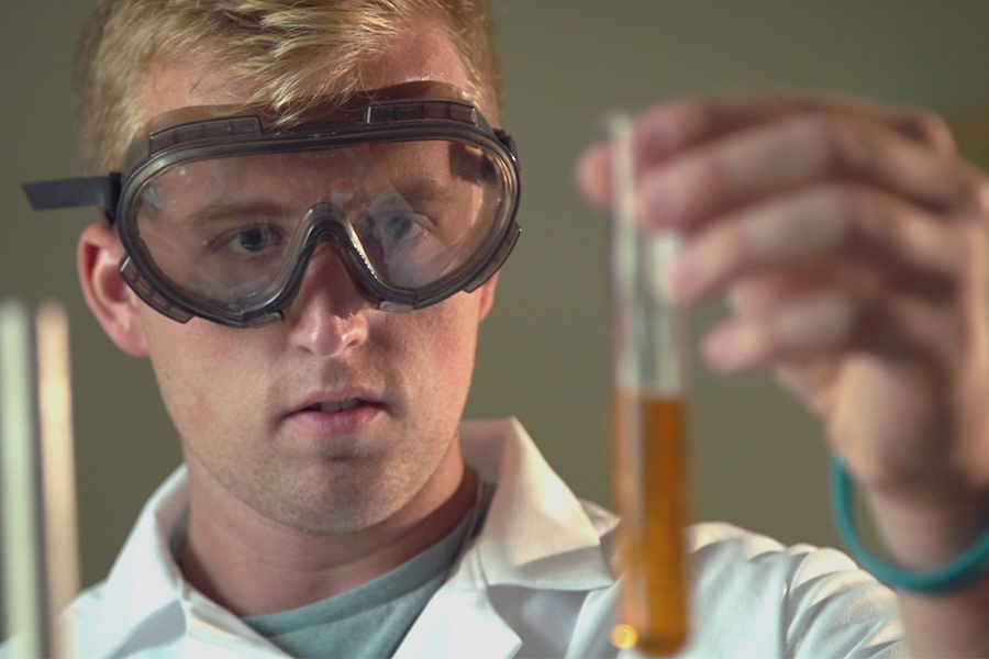 Rider looking at a test tube.