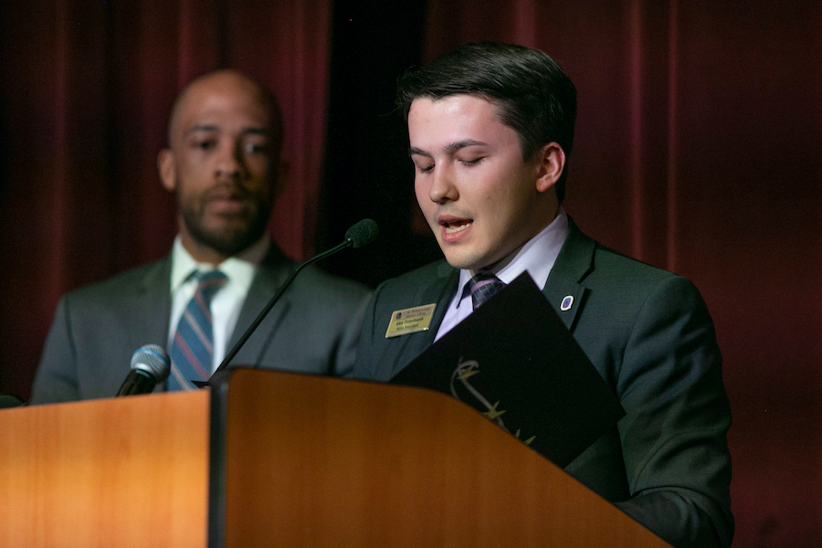 Alex Ostermann speaks at a podium.