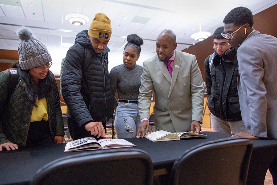 UW-Whitewater students look at high school yearbooks.