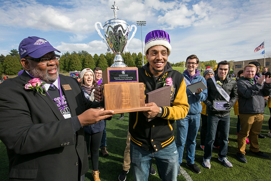 Purcell Pearson smiles as he holds the Homecoming trophy and wears the Homecoming crown.