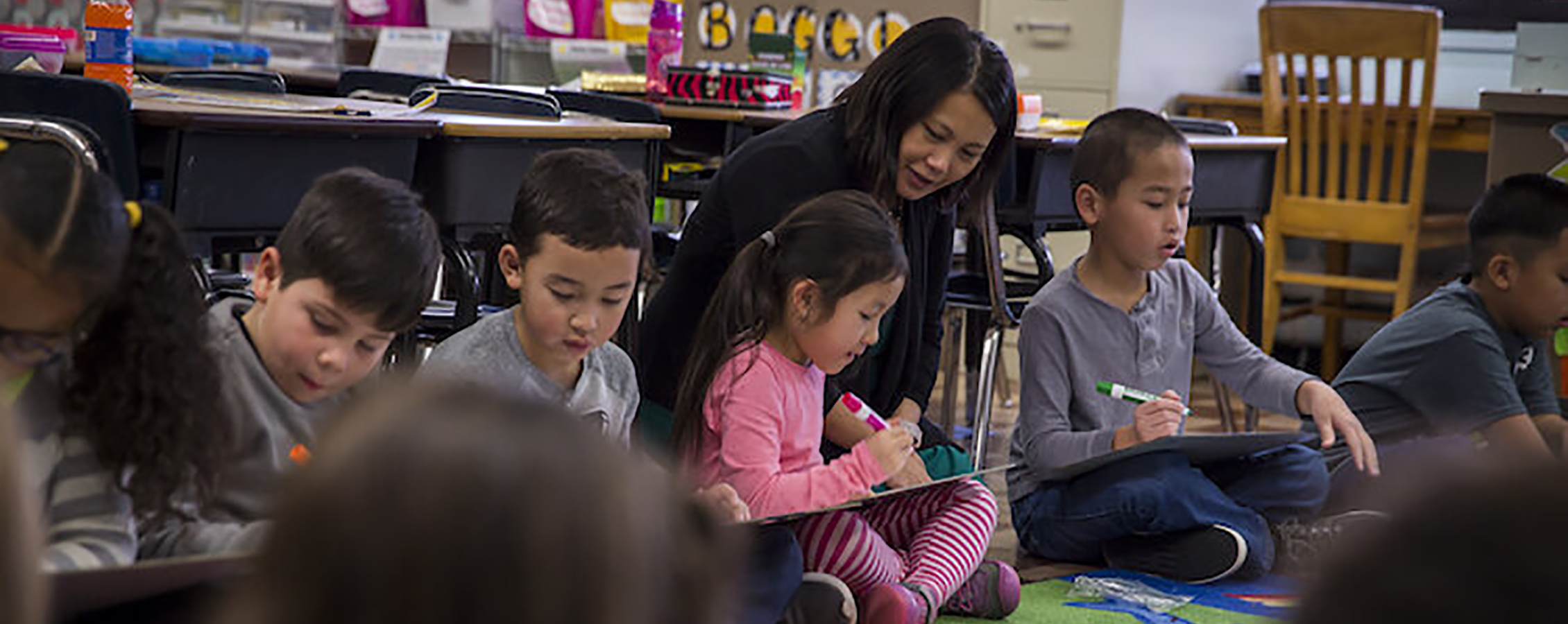 Hmong woman sitting with children.