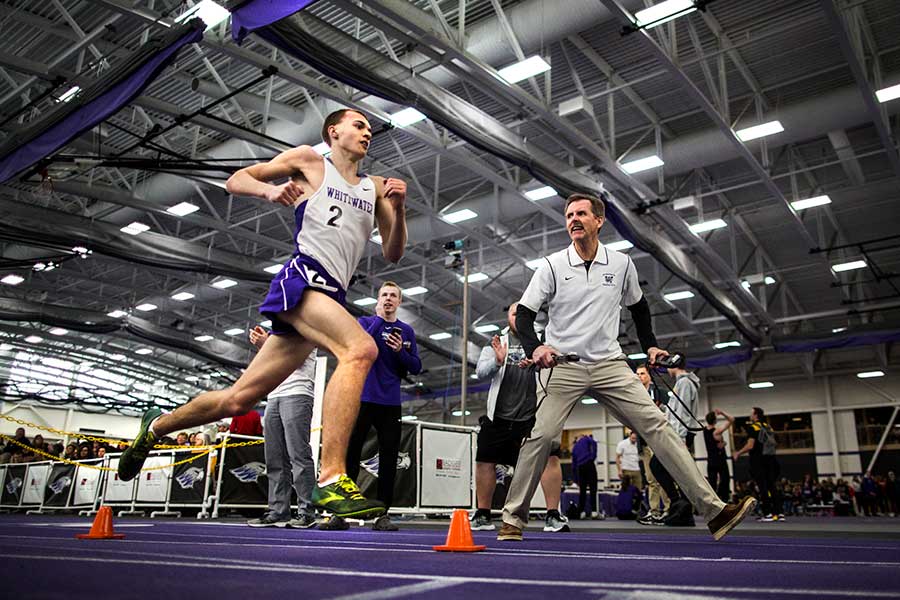 David Fassbender running on an indoor track.