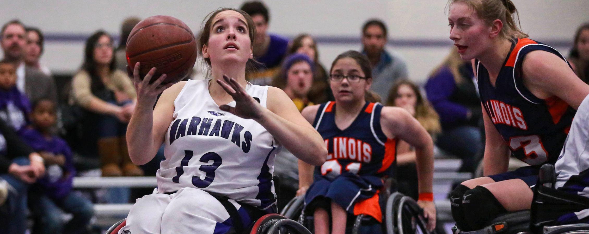 Becca Murray on the basketball court with ball in hand.