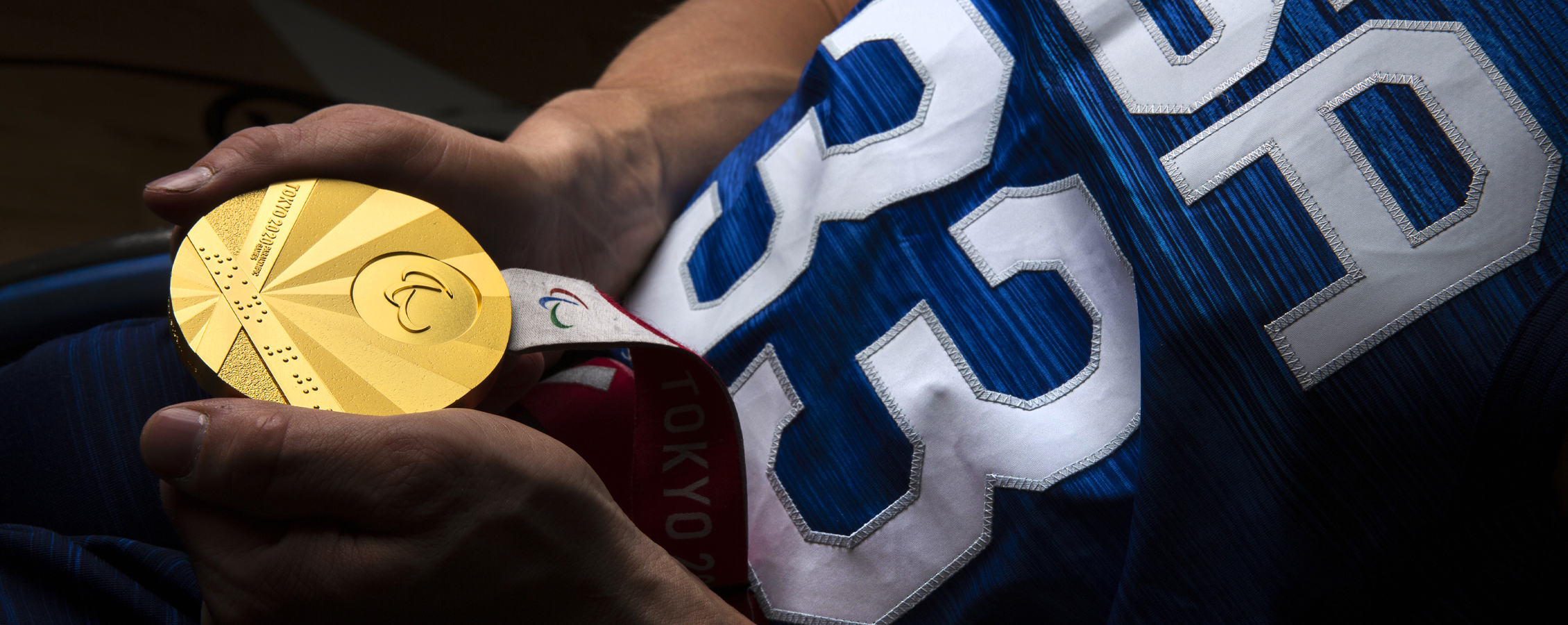 John Boie holds his gold medal in his hands.