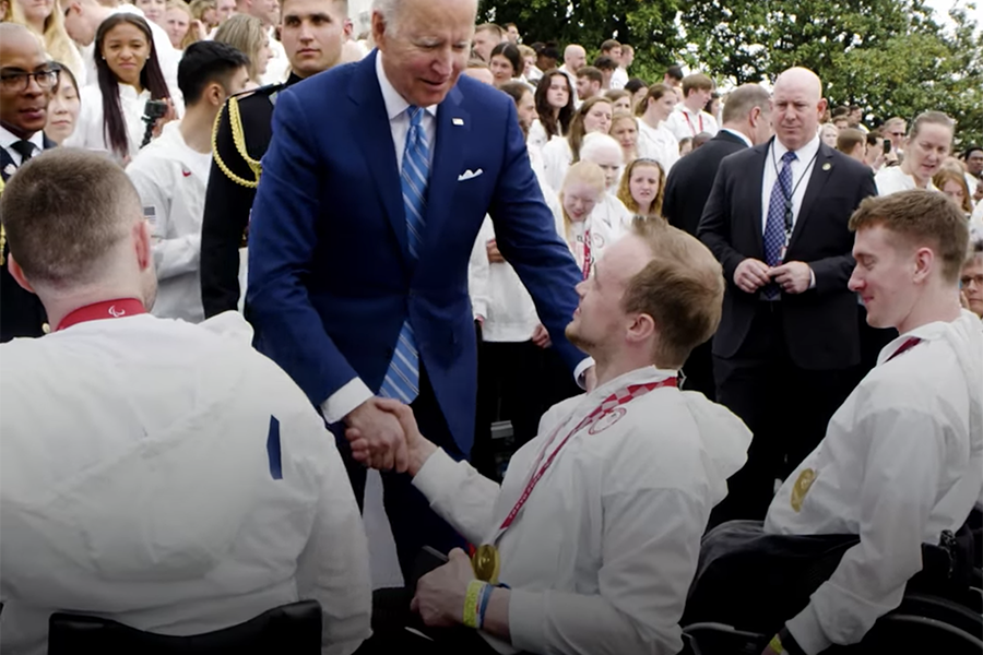 John Boie shakes hands with President Biden in front of the White House.