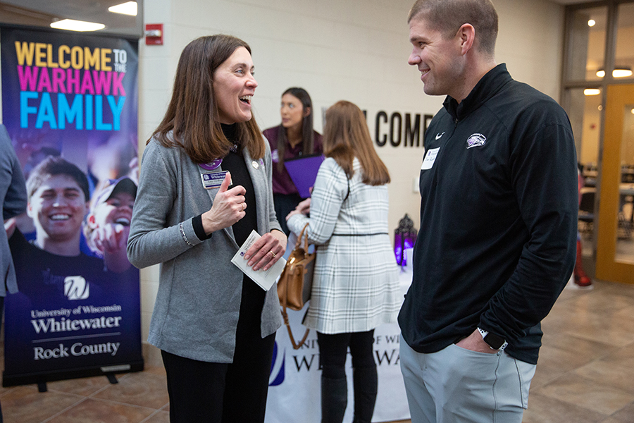 Amy Oeding talks with Warhawk Football head coach Jace Rindahl.