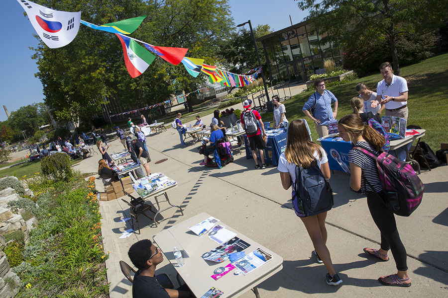 People walk down a sidewalk during a Global Experiences Fair.