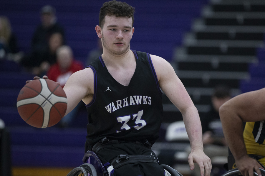 Warhawk AJ Fitzpatrick dribbles the ball.