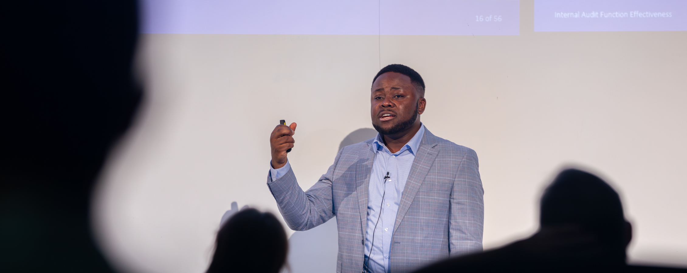 Patrice Achu defends his dissertation in front of a crowd.