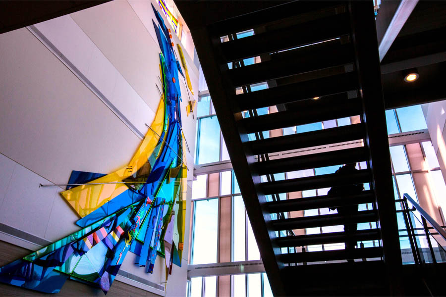 Light comes through the windows and the stairwell in the lobby of Hyland Hall.