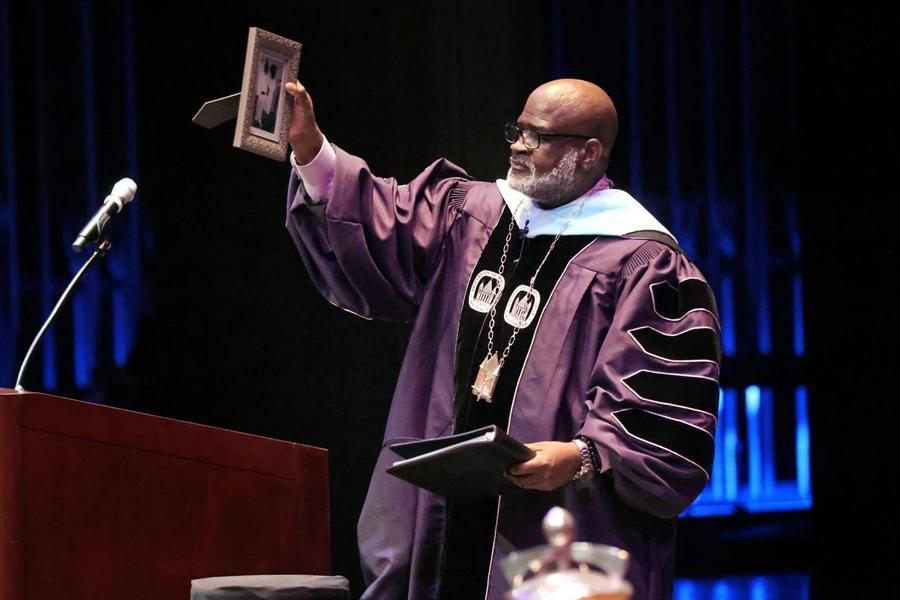 Chancellor King holding up a picture frame