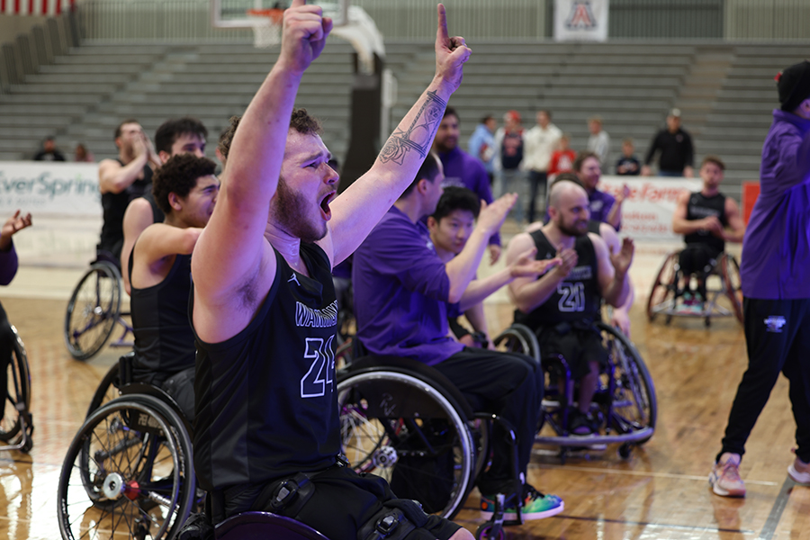 AJ Fitzpatrick celebrates on the court with his arms raised.