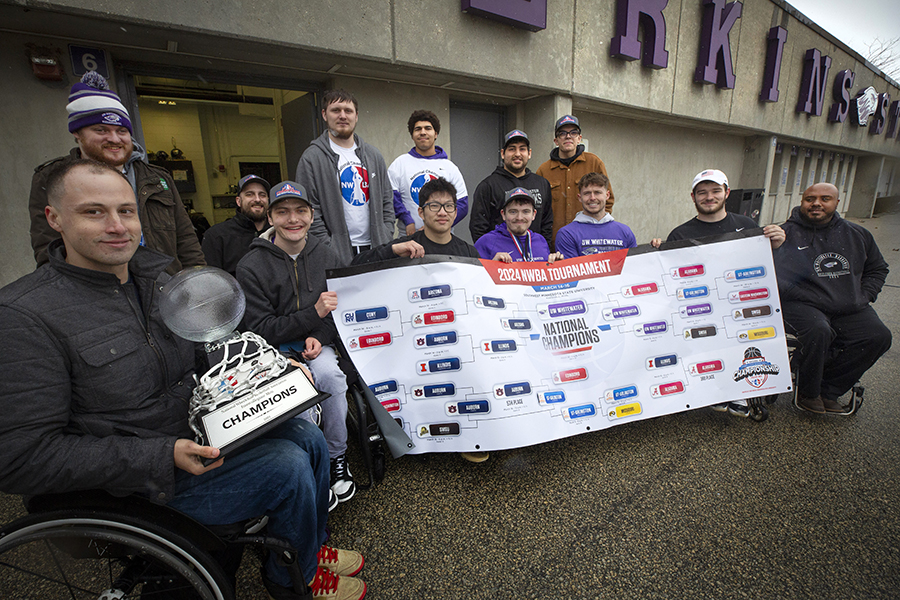 Warhawk wheelchair basketball athletes hold their national champion trophy.