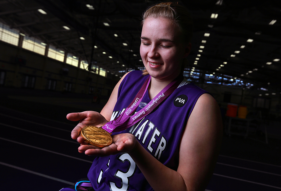 Mareike Miller smiles and looks at her gold medal.