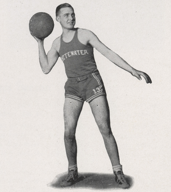 A black and white yearbook photo of Harold Perry holding a basketball.