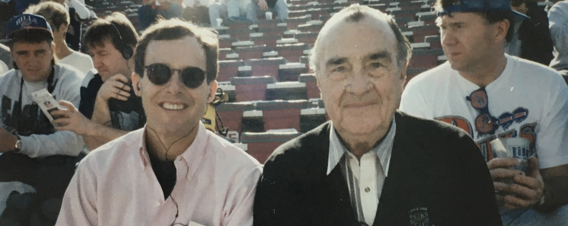 Mark and Harold Perry sit in the stands.