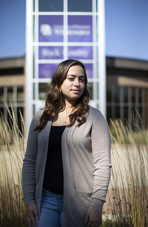 Isabelle Clowes stands outside with the Rock County campus in the background.