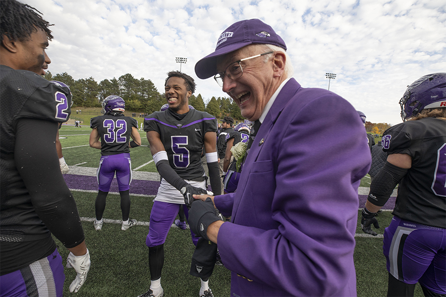 Glenn Hayes celebrates on the football field.