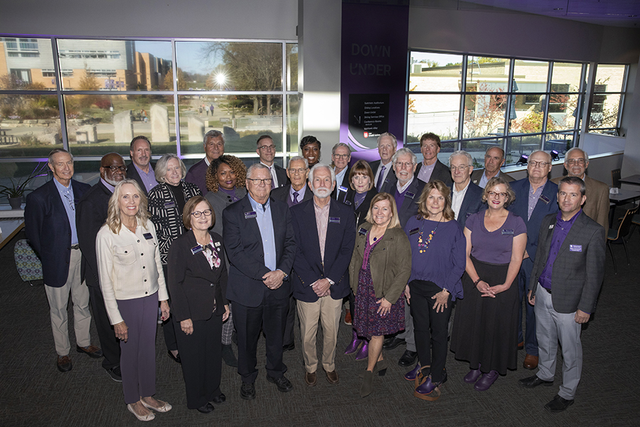 Group of people smiling at the camera in the University Center.