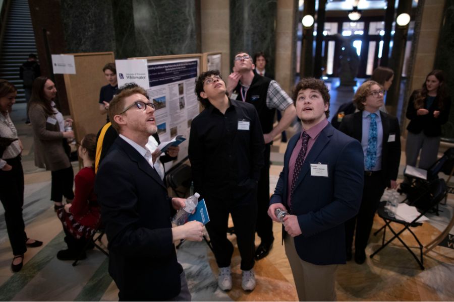 Photo of three students looking up at the Madison Capitol.